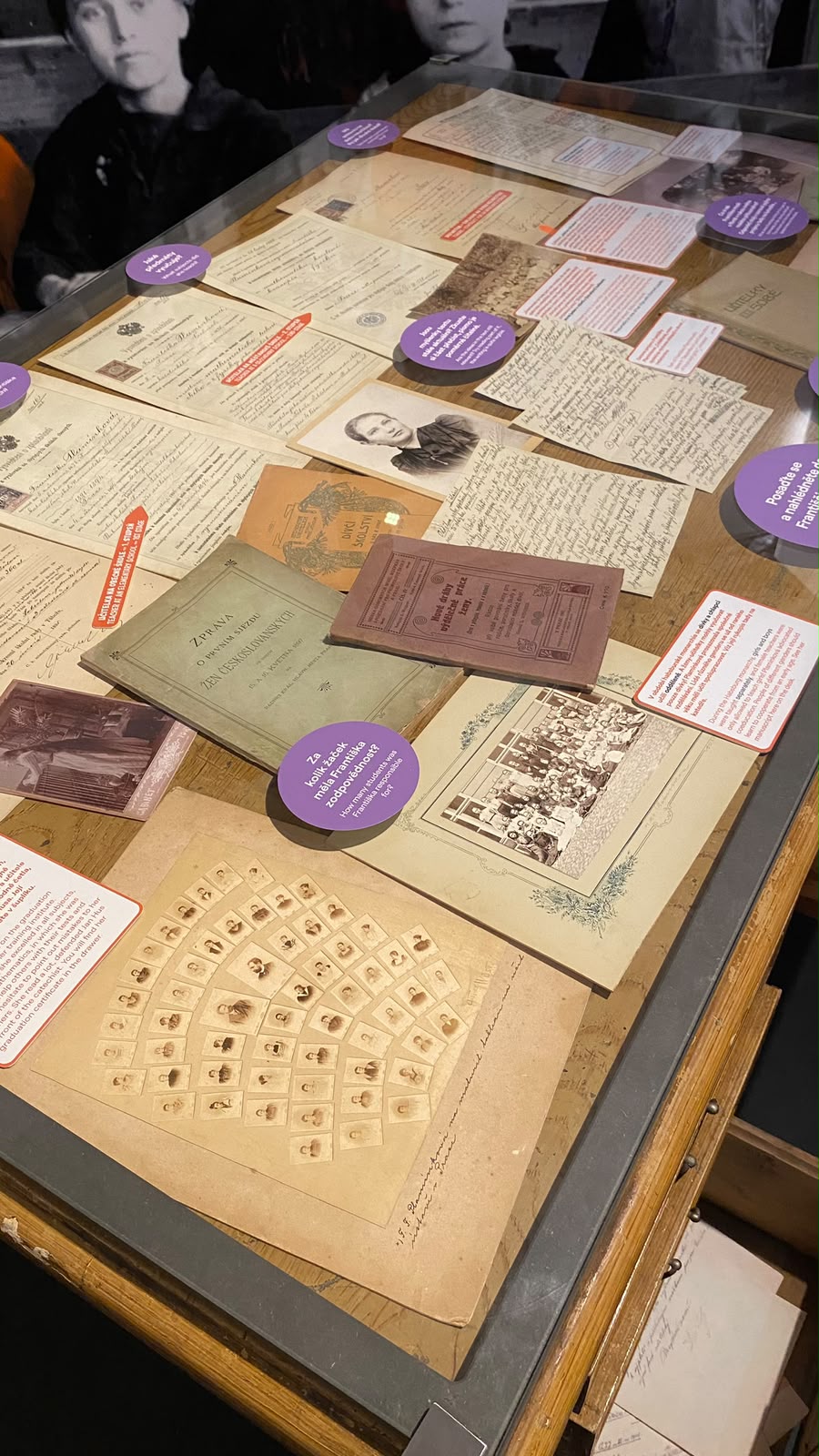 Museum display case with old documents, letters and photos about Czech women's education